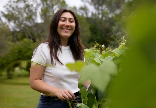 Smiling woman enjoying time outdoors in a garden, free from hayfever symptoms
